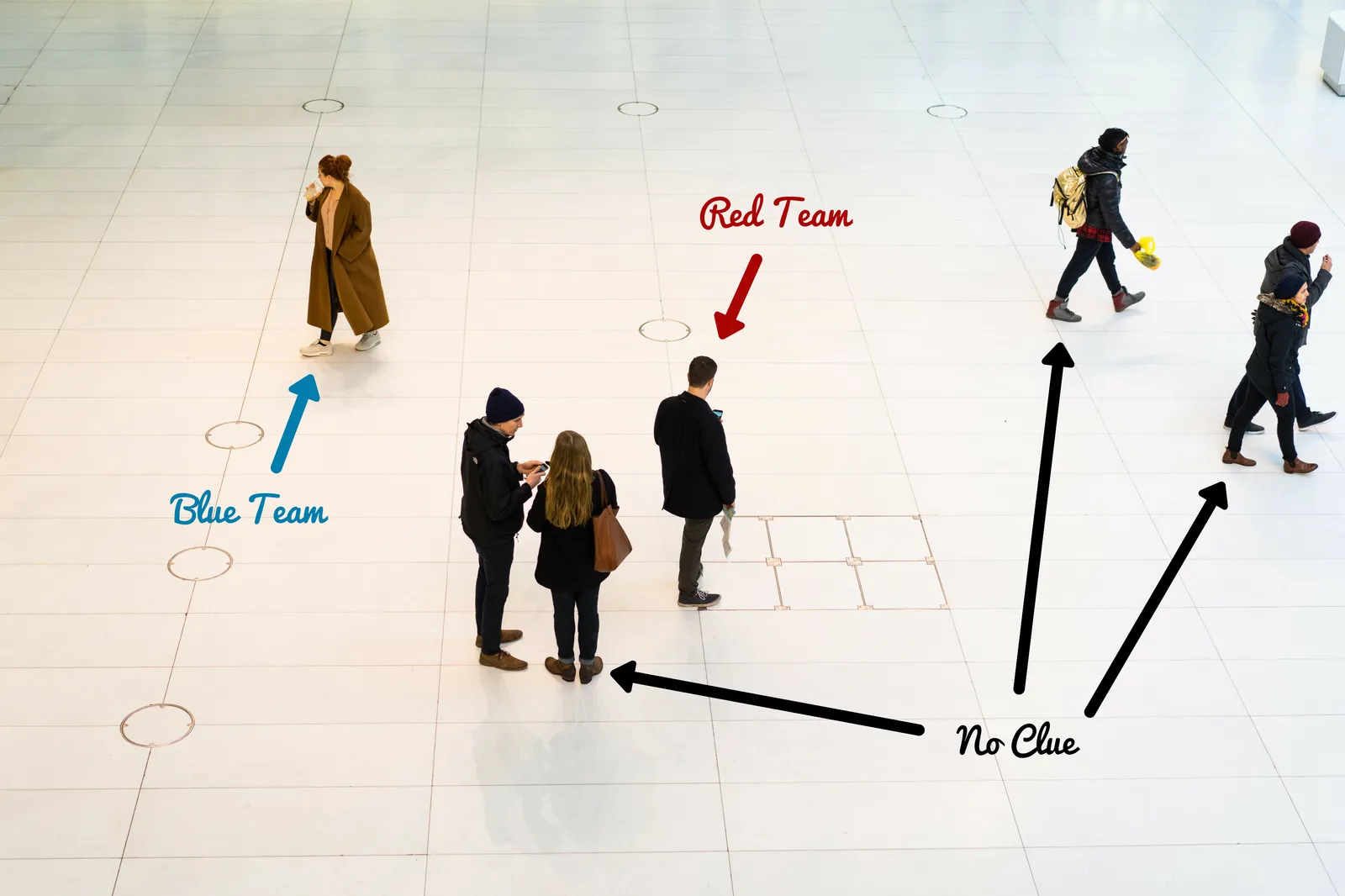 Overhead view of a game in progress at the Oculus — players from Blue Team and Red Team moving through the crowd, bystanders completely unaware